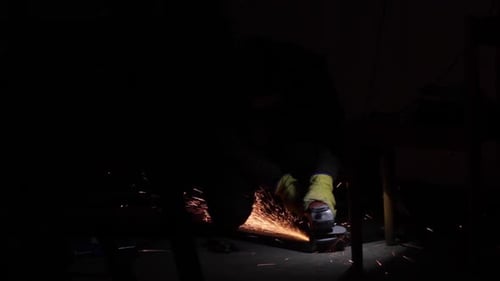 Hand saw grinding cleaning at a dark tool workshop, medium shot