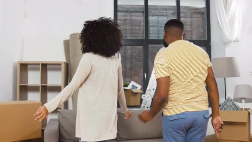 Happy Couple Dancing Together in New Home