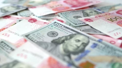 Hundred yuan RMB and hundred USD, Chinese and American paper money, flowing on the table, close up