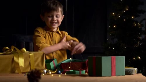 Excited Boy Opening Christmas Gifts at Night