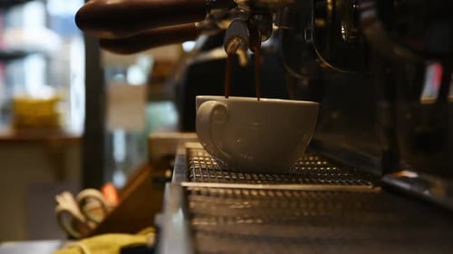 Espresso Pours into Cup from Coffee Machine