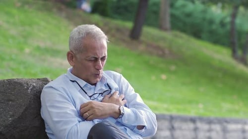 The man is having a heart attack.