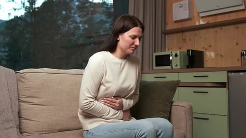 Woman Suffering From Abdominal Pain at Home