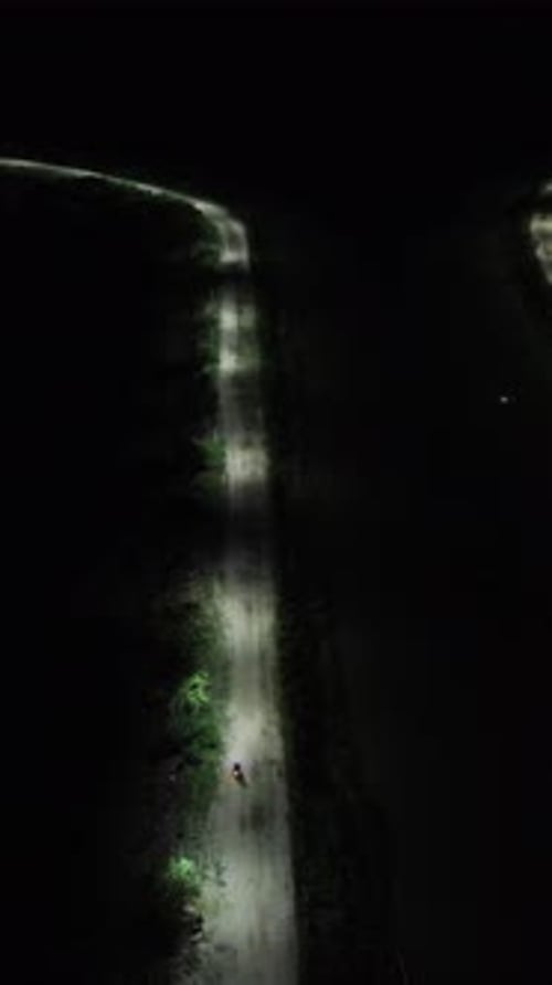 Vertical drone footage of deserted street at night