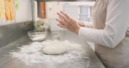 4k video footage of an unrecognizable baker shaping dough in a bakery