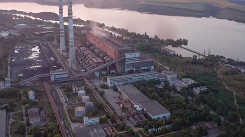 Site with high-voltage lines on the background of the road and trees at sunset.
