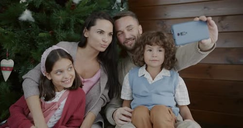 Happy Family Taking Christmas Selfie Together