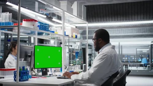 Scientists Working in a Lab with Chroma Key Monitor