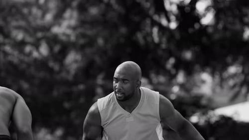 One on one street basketball game in black and white featuring african american man