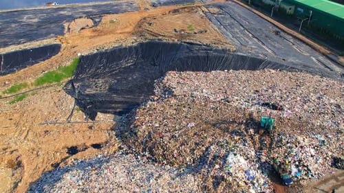 Aerial View of a Large Landfill With Backhoe