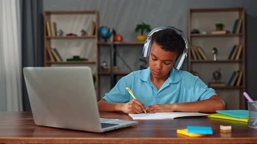 Young African American Child Boy Studying at Home Kid Sits at Desk Attends School Class Online on