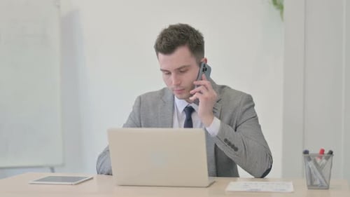 Man on Phone Receiving Bad News at Office