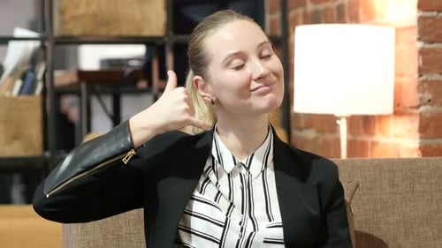 Smiling Woman Makes Call Me Gesture