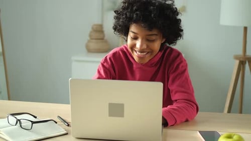 African American Girl Using Laptop at Home Office Looking at Screen Typing Chatting Reading Writing