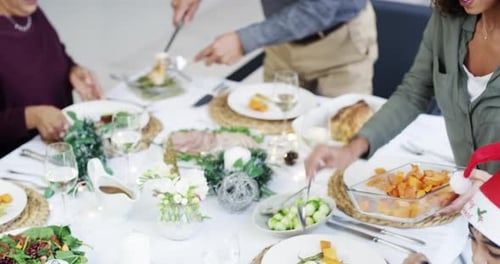 Family shares holiday meal around dinner table