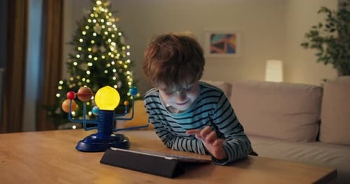 Focused Boy with Brown Hair Explores the Planets