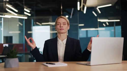 Relaxed Woman Meditating at Work in the Office