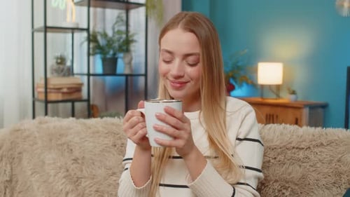 Woman Relaxing on Couch with Hot Drink