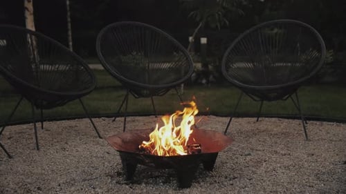 Burning Fire Pit with Chairs in the Night
