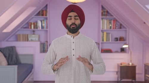 Man with Turban Talking and Gesturing Indoors