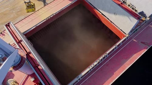 Drone Rises as Crane Loads Grain into Cargo Ship at Baltic Port Terminal