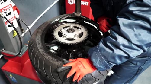 the tire fitter puts the tire on the car disc, tire fitter repairing tire