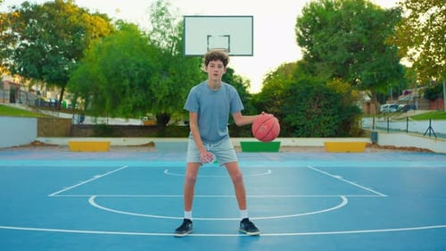 Slow Motion Street Basketball Boy Practicing Shooting a Basketball The Teenager Plays Basketball