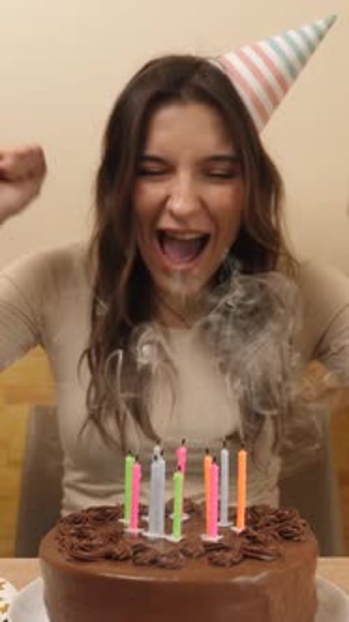 Happy Woman Lights Candles on Birthday Cake