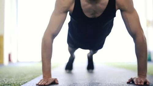 Young Fit Hispanic Man in Modern Gym Doing Push Ups