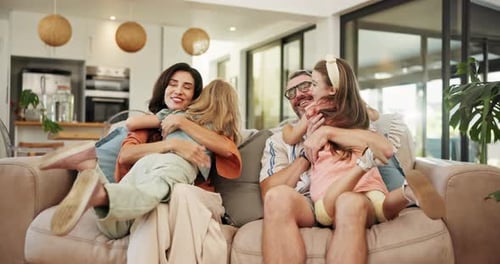 Happy Family Hugging on Sofa in Bright Home