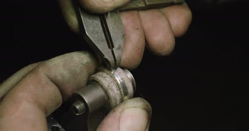 Close up of the hands of a goldsmith while he is working on a diamond ring. Concept: Style, fashio