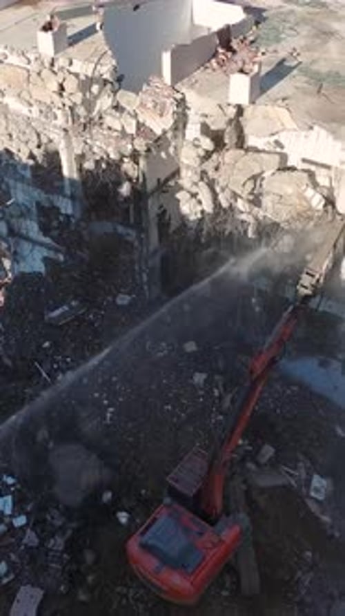 Vertical Video A Powerful Excavator Demolishes the Remains of a Building Clearing Land for an