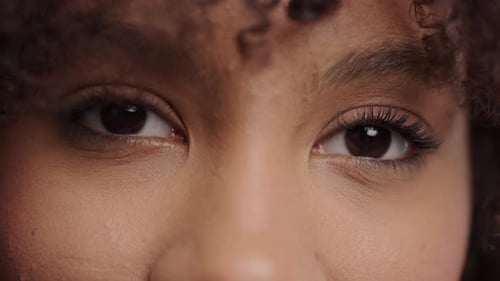 Extreme Close-Up of Eyes and Curly Hair
