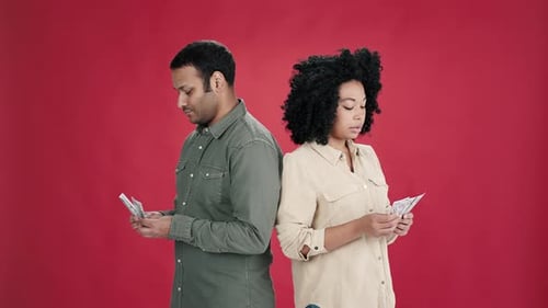 Indian Man and African American Woman Count Money and Smile