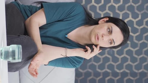 Upset Woman Talking on Phone Indoors