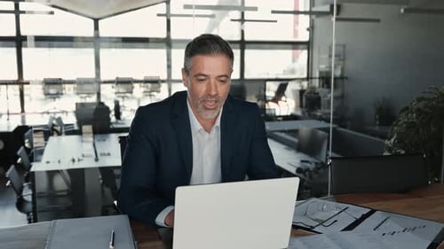 Man in Suit at Laptop in Office Video Call