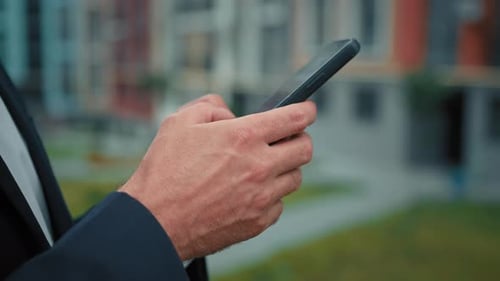 Adult Typing on Phone in Urban Setting