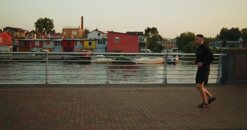 Young Athlete Jogging on a City Street at Sunset