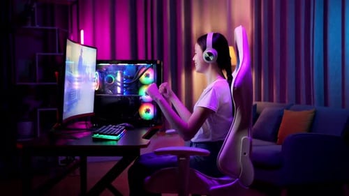 Teen Plays Video Game at Neon Computer