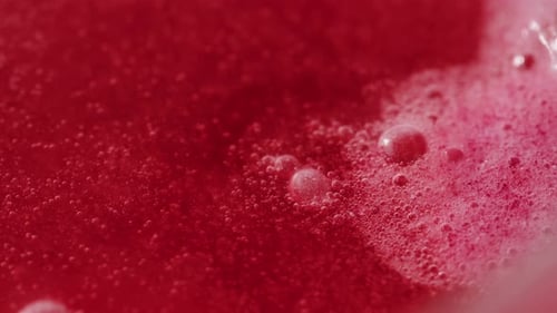 Macro Footage of Red Liquid with Bubbles
