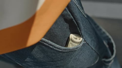 Cash Roll in Pocket of Blue Baggy Jeans
