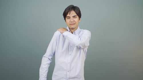 Young Man Experiencing Aching Shoulder