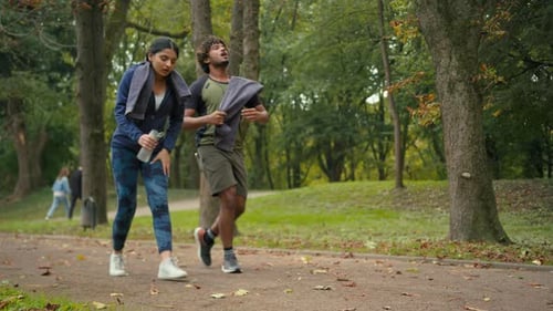 Indian Arabian Couple Jogging Outdoors Run Together Woman Man in Park Stop Pause Break Tired