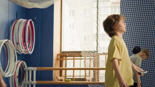 Two Children Doing Jumping RoPE Exercises in Gym