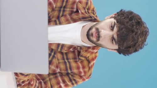 Young Adult Working on Laptop Indoors, Portrait