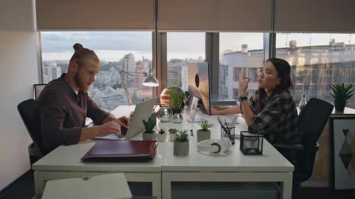 Overworked Programmers Talking At Evening Office Closeup. Focused Teammates Preparing Deadline At...