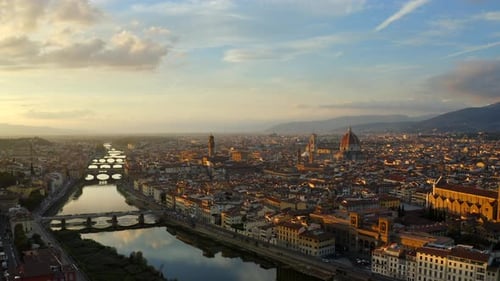 Florence, Tuscany, Italy, October 2021. Drone gradually ascends while pulling back from the Arno riv