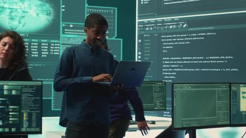 Team of Programmers Working in a Dark Office