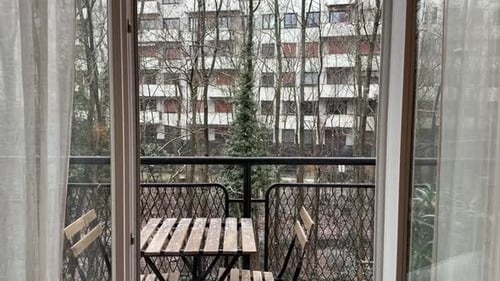 Apartment Balcony View With Table and Chairs