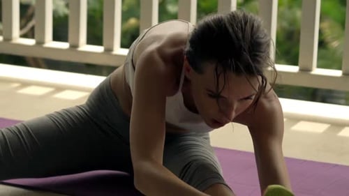 Young Woman Exercising, Stretching Body on Mat on Terrace 30s